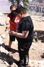 students exploring rocks at the grand canyon
